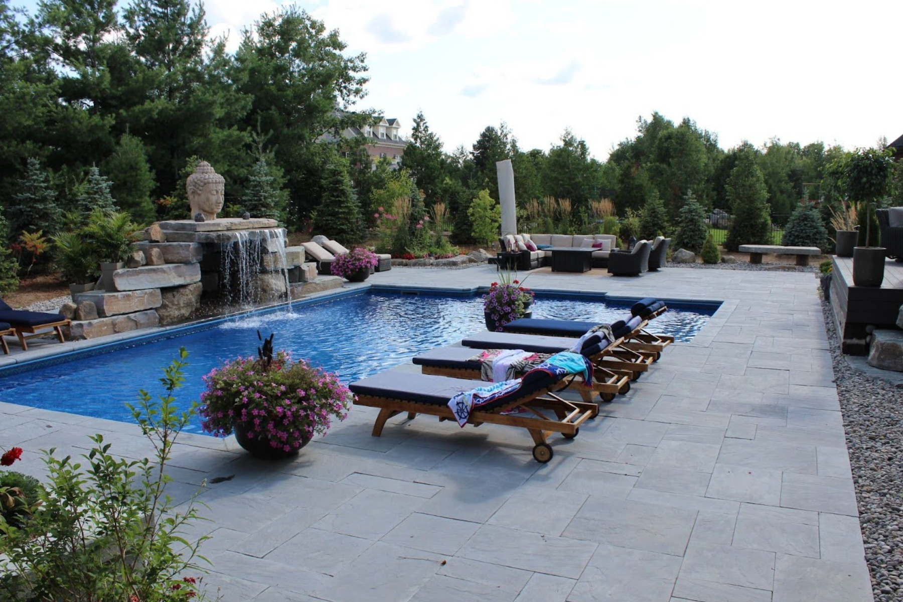 Wide shot of pool with landscaping by Mallette Landscaping